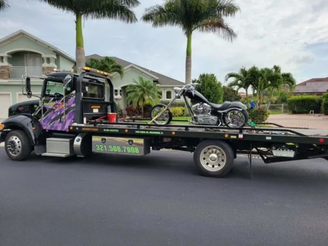 Imperial Towing flatbed transporting a motorcycle in Melbourne, Florida